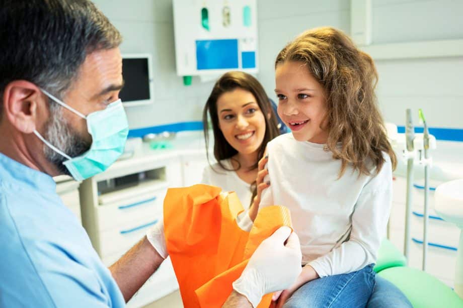 Dentist with child and parent